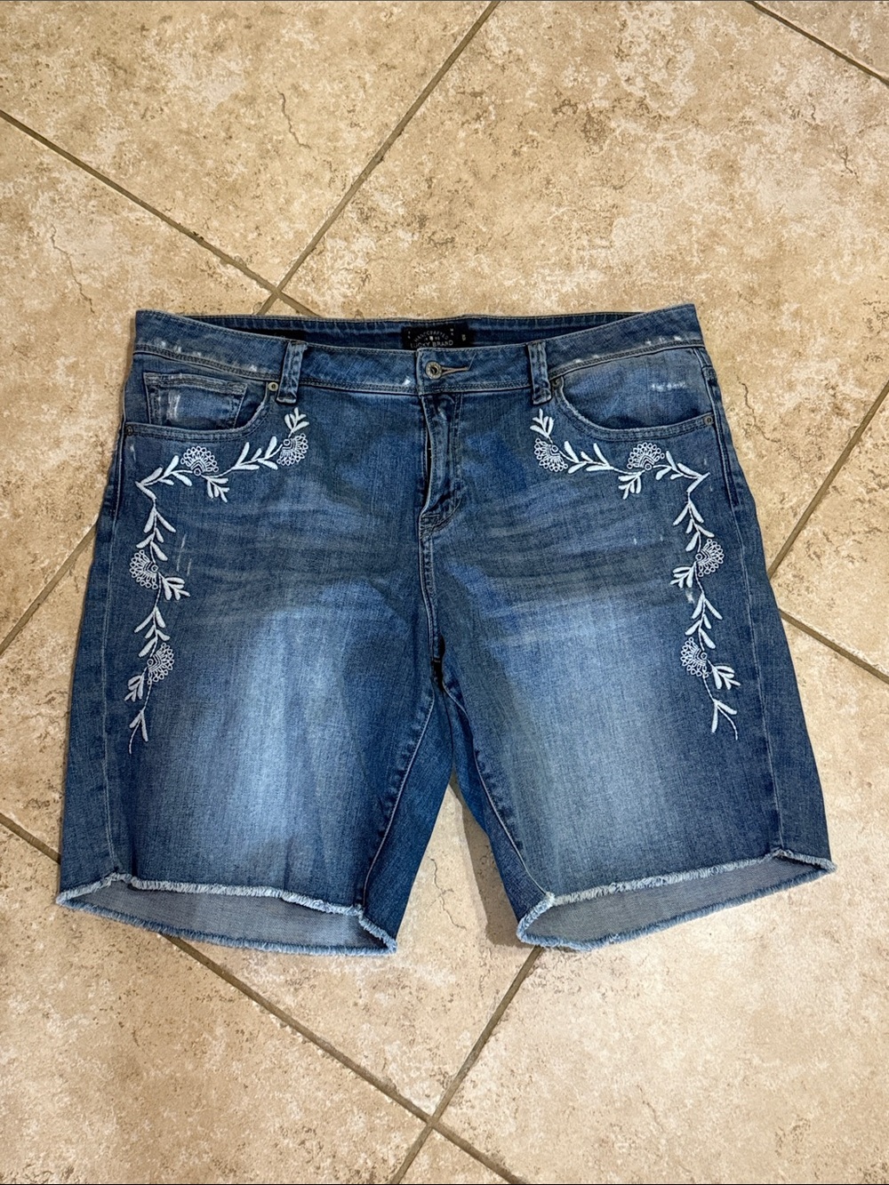 Lucky Brand navy label on dark blue denim waistband